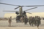 Afghan National Army soldiers with 215th Corps and U.S. Marines with Task Force Southwest disembark a CH-47 Chinook during Operation Maiwand Six near Gereshk, Afghanistan, Sept. 25, 2017. Key leaders from both forces met to discuss recent progress and develop plans for the mission. Maiwand Six combines multiple elements of the Afghan National Defense and Security Forces with advising and assistance from the Task Force, and is designed to bolster security in Gereshk and surrounding areas. (U.S. Marine Corps photos by Sgt. Lucas Hopkins)