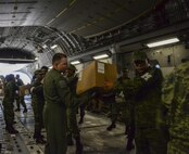 U.S. Air Force Major Bryon Shields, 21st Airlift Squadron pilot, works with a member of the Mexican army to transfer boxesf infant hygiene supplies from a U.S. Air Force C-17 Globemaster III to a supply truck Sept. 22 at Ixetepec Airport, Oaxaca, Mexico. At the request of Mexican civil authorities, the C-17 and its six-member crew from Travis Air Force Base, Calif., assisted U.S. efforts to provide humanitarian aid to Mexico by airlifting over 31,000 pounds of hygiene and medical supplies to the area after a 7.1-magnitude earthquake struck Mexico City Sept. 19. (U.S. Air Force photo / 2nd Lt. Sarah Johnson)