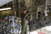 Senior Airman Dakota Maynor, 21st Airlift Squadron loadmaster, guides a forklift to the ramp of a C-17 Globemaster III to download cargo Sept. 23 at Benito Juárez International Airport, Mexico City, Mexico. At the request of the Mexican government, the C-17 and its six-member crew from Travis Air Force Base, Calif., assisted U.S. efforts to provide aid to Mexico by airlifting over 130,000 pounds of food, water, hygiene and medical supplies to Mexico City and Oaxaca after a 7.1-magnitude earthquake struck the area Sept. 19. (U.S. Air Force photo / 2nd Lt. Sarah Johnson)