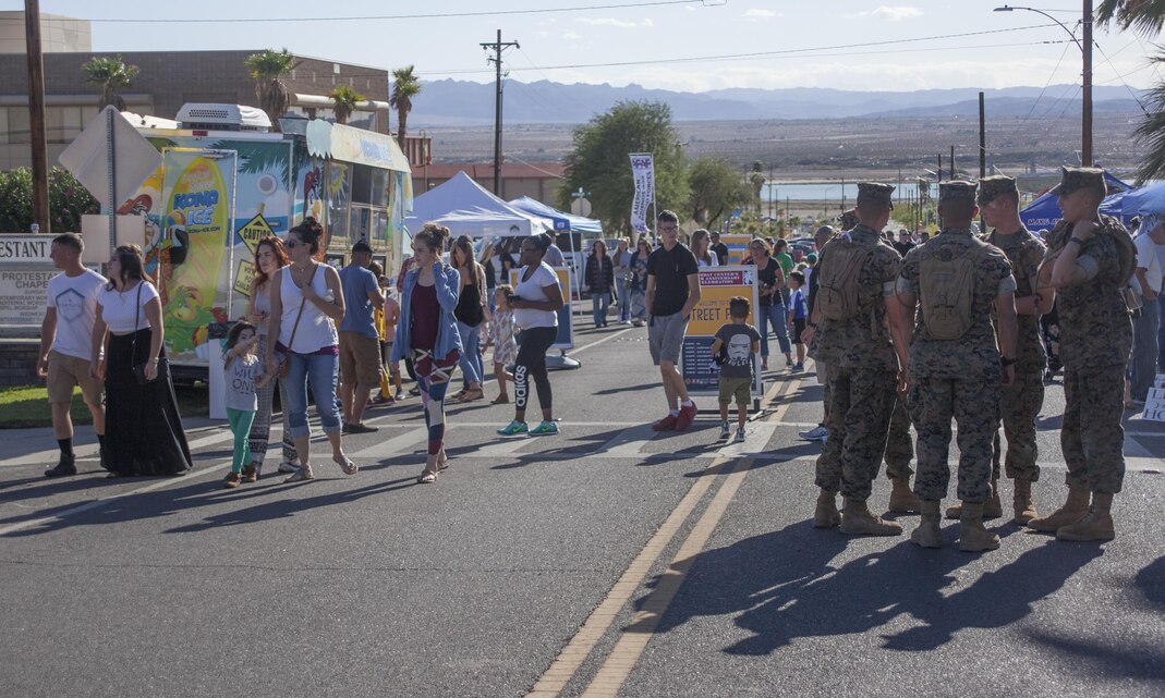 Combat Center patrons enjoy the street fair during the Marine Corps Air Ground Combat Center’s 65th anniversary aboard the Combat Center September 23. In celebration of the anniversary, the Combat Center hosted a variety of festivities, including a street fair, a Family Fun Zone and a contest of physical fitness called the Battle of Bandini. (U.S. Marine Corps photo by Lance Cpl. Natalia Cuevas)