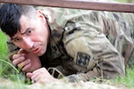 Staff Sgt. Scott Dandrea, 232nd Medical Battalion, going through the low crawl portion of the obstacle course during the AMEDDC&S Best Medic Completion at Joint Base San Antonio-Camp Bullis Sept. 25-28.