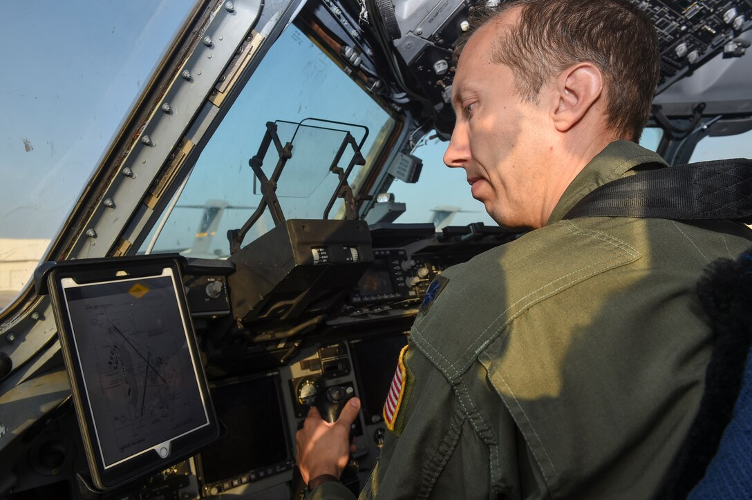 Lt. Col. Thomas Clark, 437th Operations Group deputy chief of standards and evaluations, uses the new Electronic Flight Bag mount modification on the flightline in Joint Base Charleston, S.C., Sept. 29, 2017.