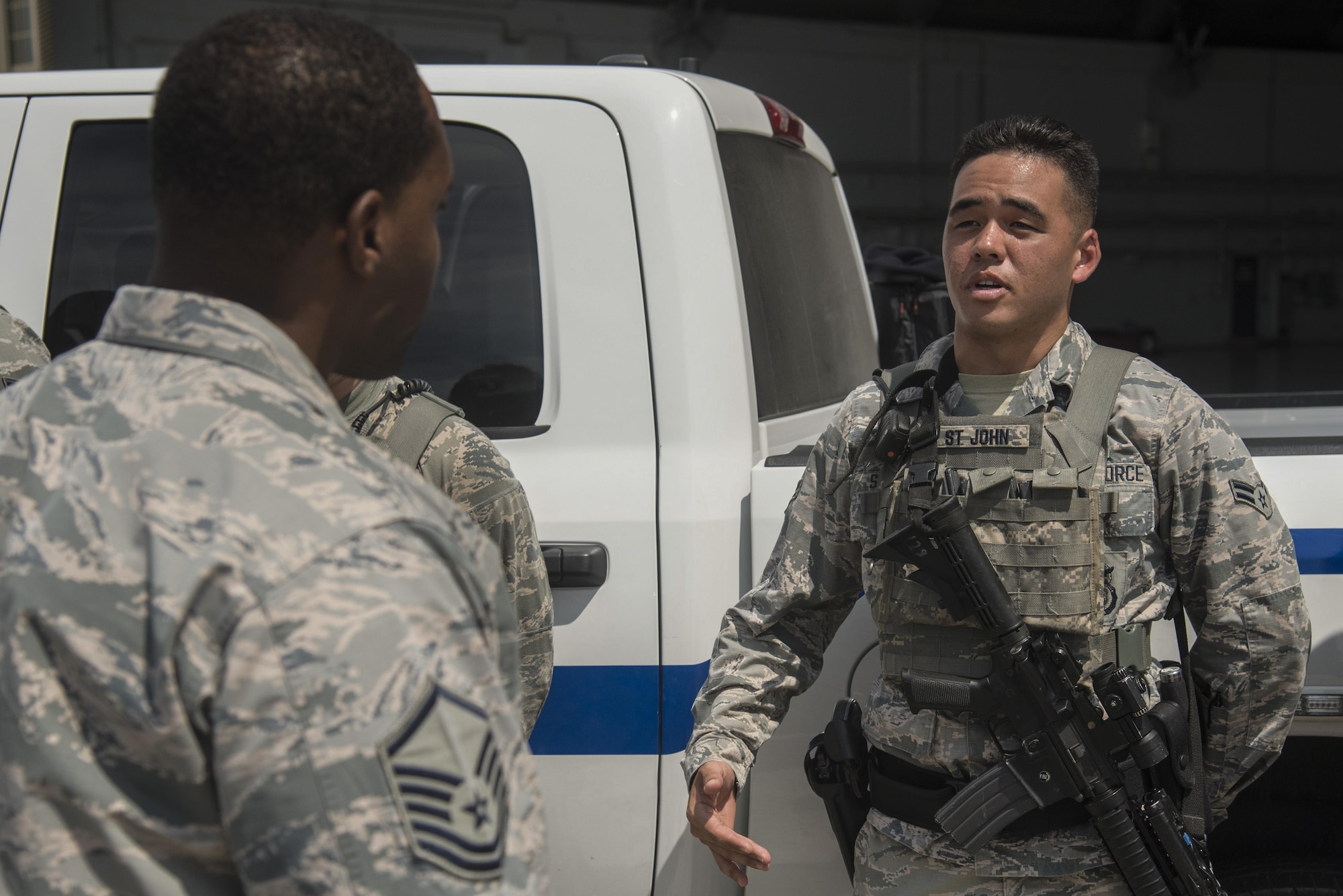 U.S. Air Force Airman 1st Class Randall St. John, an entry controller assigned to the 6th Security Forces Squadron, delivers his post briefing to Master Sgt. Adrian Wright, sustainment services flight superintendent assigned to the 6th Force Support Squadron, at MacDill Air Force Base, Fla., Sept. 21, 2017.