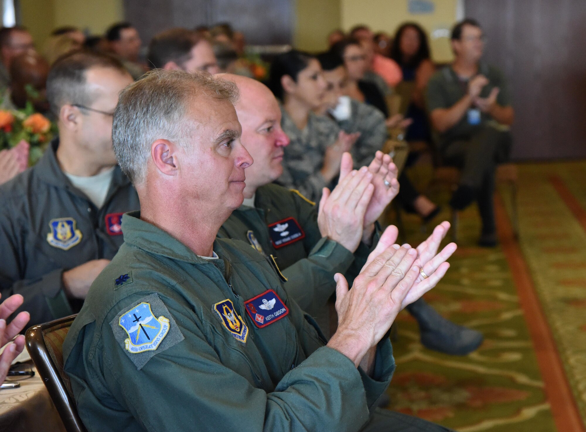 Lt. Col. Keith Gibson, 403rd Operations Group deputy commander, applauds during the Biloxi Chamber Morning Call at the Bay Breeze Event Center Sept. 28, 2017, on Keesler Air Force Base, Mississippi. Local business and community leaders attended the event to learn more about the base’s mission and its Airmen. During the event, hosted by the 81st Training Wing, members of the 334th Training Squadron drill team performed and several Keesler Airmen shared their story about why they joined the Air Force. (U.S. Air Force photo by Kemberly Groue)