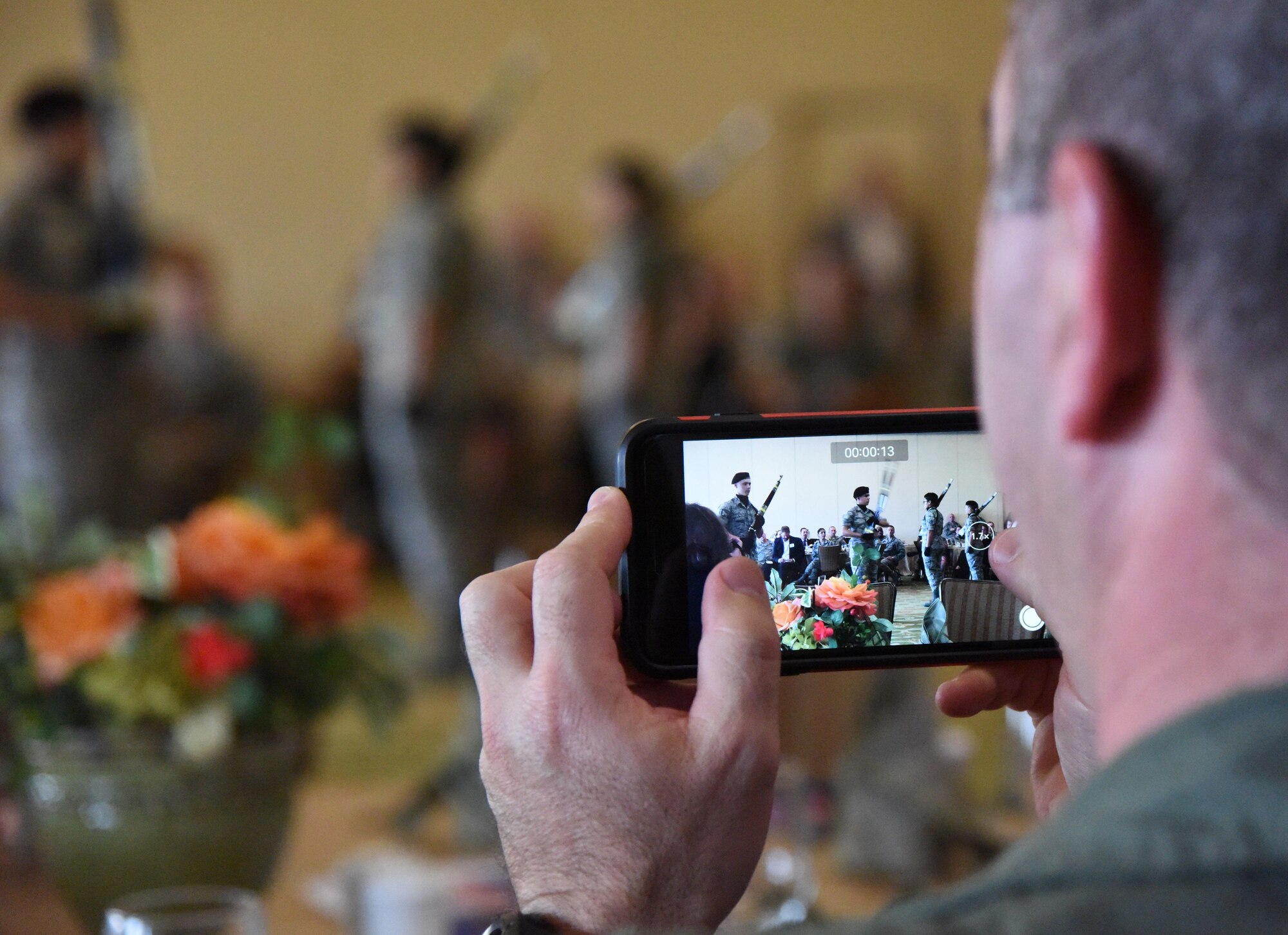 Col. Brian May, 403rd Operations Group commander, videos a performance by the 334th Training Squadron drill team during the Biloxi Chamber Morning Call at the Bay Breeze Event Center Sept. 28, 2017, on Keesler Air Force Base, Mississippi. Local business and community leaders attended the event to learn more about the base’s mission and its Airmen. During the event, hosted by the 81st Training Wing, members of the 334th Training Squadron drill team performed and several Keesler Airmen shared their story about why they joined the Air Force. (U.S. Air Force photo by Kemberly Groue)