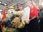 Brig. Gen. Heather Pringle, commander, 502nd Air Base Wing and Joint Base San Antonio, signs the Fire Prevention Week proclamation at Fire Station No. 1 at Joint base San Antonio-Fort Sam Houston Sept. 27.