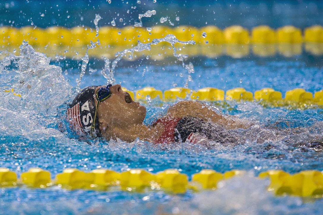 An athlete swims backstroke.