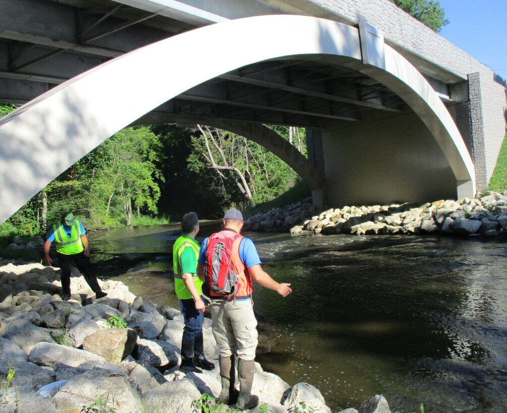 USACE regulator, Douglas Kapusinski, discusses permit compliance with representatives from the Summit County Engineers office, at a bridge replacement project site.