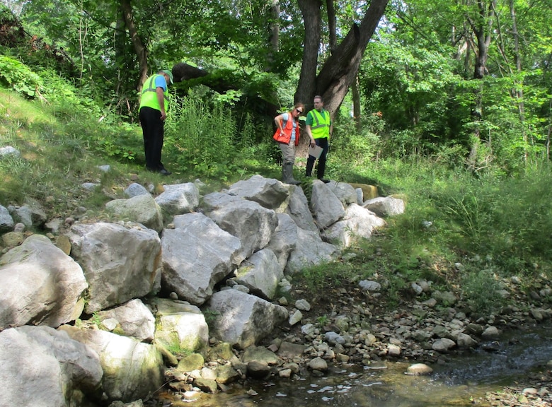 USACE regulator, Tina Stonemetz, reviews permit conditions at a bank stabilization site with representatives from the Summit County Engineers office on July 26, 2017.