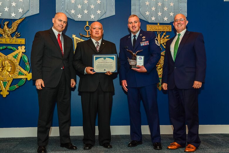 From left to right, The Honorable Kenneth P. Rapuano, Assistant Secretary of Defense for Homeland Defense and Global Security, Bob Cronan, the flight chief of readiness and emergency management, and Master Sgt. Timothy Bricker, the superintendent of the emergent readiness flight, both assigned to the 28th Civil Engineer Squadron, and Mr. Robert G. Salesses, the Deputy Assistant Secretary of Defense for Homeland take a group photo during an award ceremony in the Pentagon Hall of Heroes, Washington, D.C., Sept. 24, 2017. Recognized for their efforts and cooperation, the Airmen of emergency management, explosive ordnance disposal and the fire department worked together to achieve and exceed the national preparedness goal, resiliency throughout the nation. (U.S. Air Courtesy Photo)