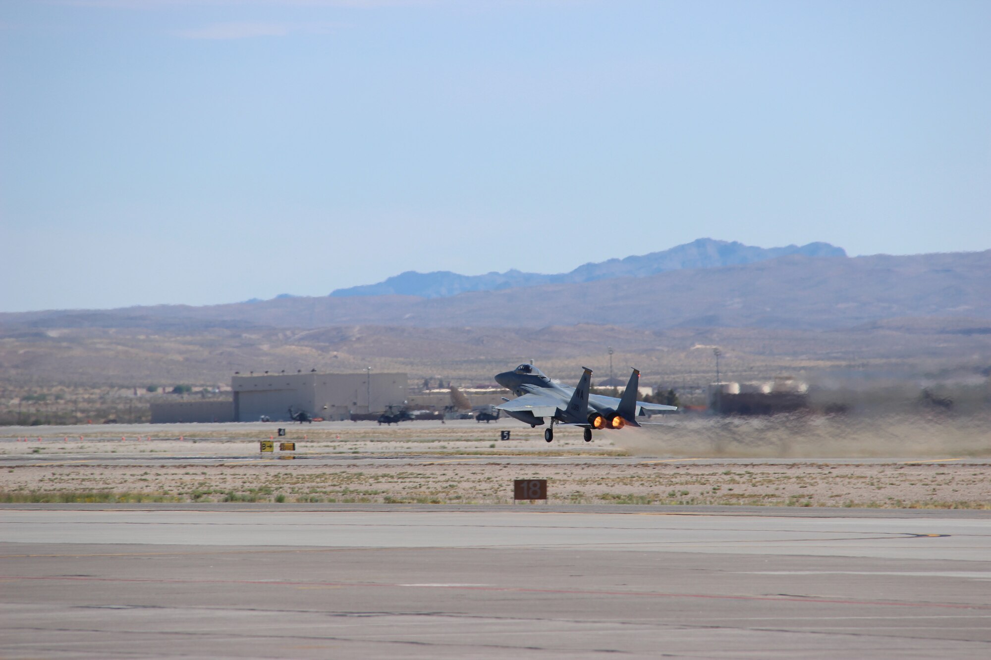 An F-15C Eagle piloted by Col. Brian “Spiderman” Kamp, Air National Guard advisor to the Air Force Warfare Center, takes off from the runway September 27, 2017, at Nellis Air Force Base, Nevada. Kamp’s 4,000 flight-hours is equivalent to more than 165 continuous days piloting the F-15C. (U.S. Air Force photo by Susan Garcia/Released)