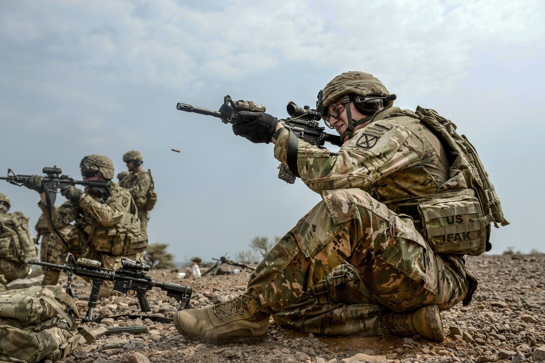 Soldiers fire weapons.