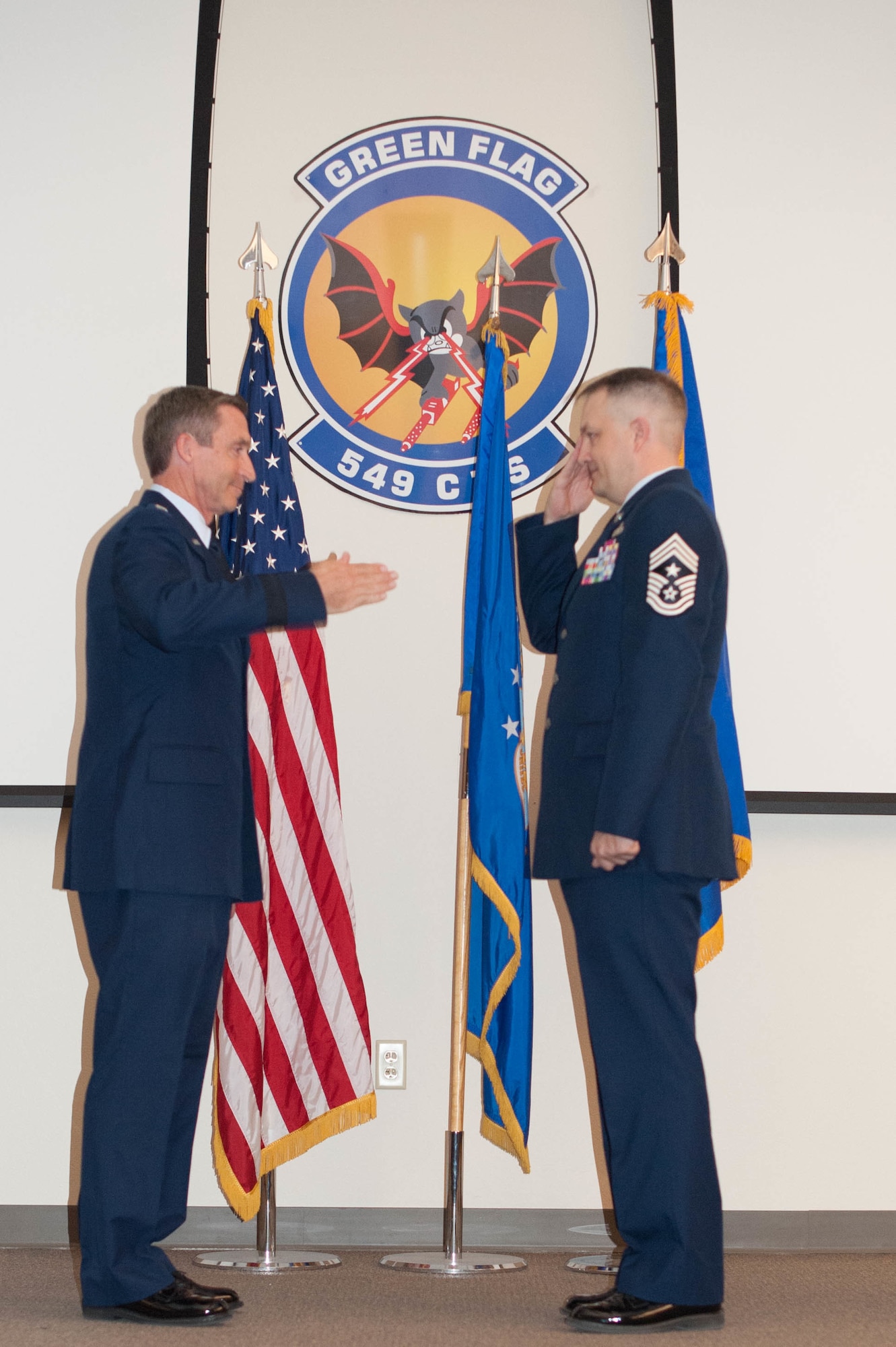 Maj. Gen. Ronald B. "Bruce" Miller returns a salute to Chief Master Sgt. James Loper during the Assumption of Responsibilities Ceremony at Nellis Air Force Base, Nevada, on September 27. Chief Master Sgt. Loper succeded Chief Master Sgt. Thomas Brandhuber as Tenth Air Force Comand Chief Master Sgt. takng on the responsibilities for the morale and welfare of almost 20,000 Airmen in 10th Air Force. (Air Force photo by Lt. Col. Jessica D'Ambrosio)