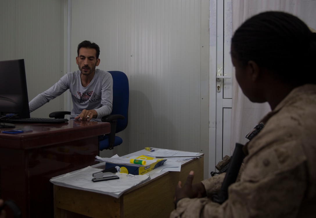A U.S. Marine advisor with Task Force Southwest meets with the bank manager at 1st Brigade, near New Garm Ser, Afghanistan, Sept. 23, 2017. The advisor met with the manager to learn about bank operations, the process for the solders to withdraw money as well as uncover any shortfalls to better improve the bank. As part of the new U.S. South Asia strategy, Marines are advising down to the brigade- and kandak-levels where necessary to support Afghan National Defense and Security Force operations. (U.S. Marine Corps photo by Sgt. Justin T. Updegraff)