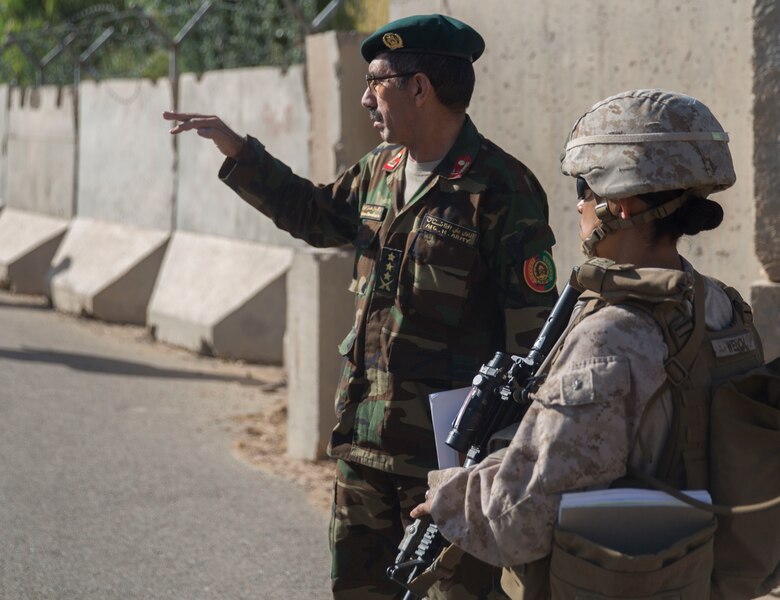 A U.S. Marine advisor with Task Force Southwest meets with her counterpart, Col. Hasan Gul, the Afghan National Army 215th Corps G-1, at 1st Brigade, near New Garm Ser, Afghanistan, Sept. 26, 2017. As part of an Expeditionary Advisor Package, the advisor joined her counterpart on a visit to 1st Brigade to allow him to solve any administration issues within the brigade, while she provided assistance as needed. As part of the new U.S. South Asia strategy, Marines are advising down to the brigade- and kandak-levels where necessary to support Afghan National Defense and Security Force operations. (U.S. Marine Corps photo by Sgt. Justin T. Updegraff)