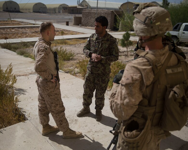 A U.S. Marine advisor with Task Force Southwest meets with his counterpart at 1st Brigade, near New Garm Ser, Afghanistan, Sept. 27, 2017. The advisor learned about the capabilities that the information operations soldiers have at Camp New Garm Ser. As part of the new U.S. South Asia strategy, Marines are advising down to the brigade- and kandak-levels where necessary to support Afghan National Defense and Security Force operations. (U.S. Marine Corps photo by Sgt. Justin T. Updegraff)