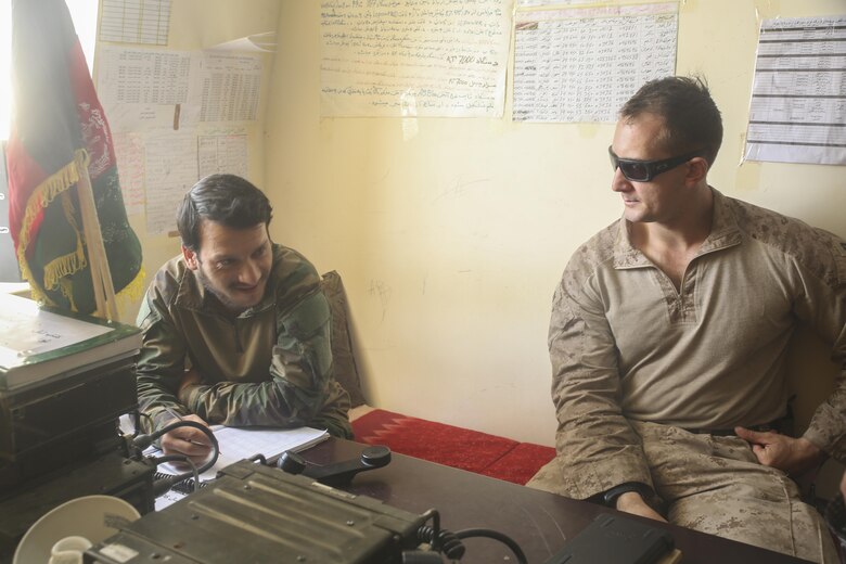 U.S. Marine Capt. Jonathan Pucci, right, an advisor with Task Force Southwest, speaks with an Afghan National Army soldier with 3rd Brigade, 215th Corps near Gereshk, Afghanistan, Sept. 27, 2017. Advisors with the Task Force are assisting their Afghan National Defense and Security Force counterparts throughout Operation Maiwand Six, providing battle tracking and air support capabilities. Various elements of ANDSF are working together to destroy insurgency in Gereshk and surrounding areas, subsequently enhancing security and governmental influence for the local populace. (U.S. Marine Corps photo by Sgt. Lucas Hopkins)