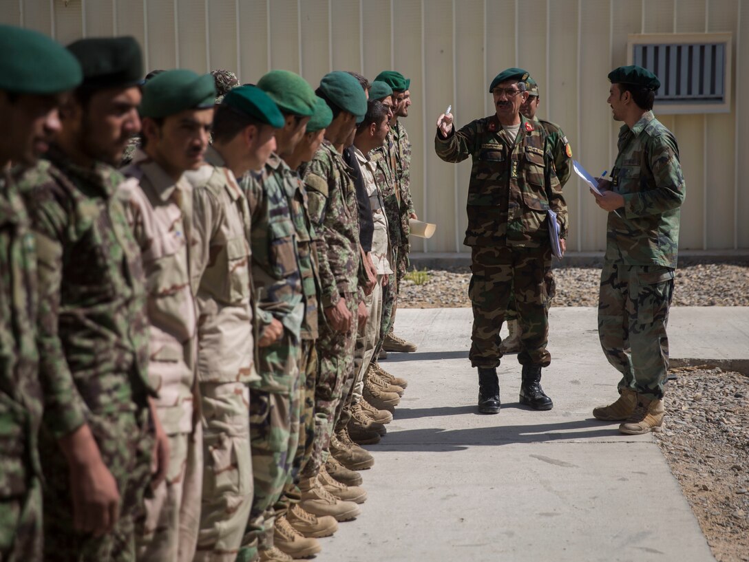 Col. Hasan Gul, the Afghan National Army 215th Corps G-1, reviews and verifies accountability reports at 1st Brigade, near New Garm Ser, Afghanistan, Sept. 27, 2017. Hasan Gul came down from the 215th Corps to personally find and solve any administrative issues within the 1st Brigade, setting an example for what should be done in the future. As part of the new U.S. South Asia strategy, Marines are advising down to the brigade- and kandak-levels where necessary to support Afghan National Defense and Security Force operations. (U.S. Marine Corps photo by Sgt. Justin T. Updegraff)