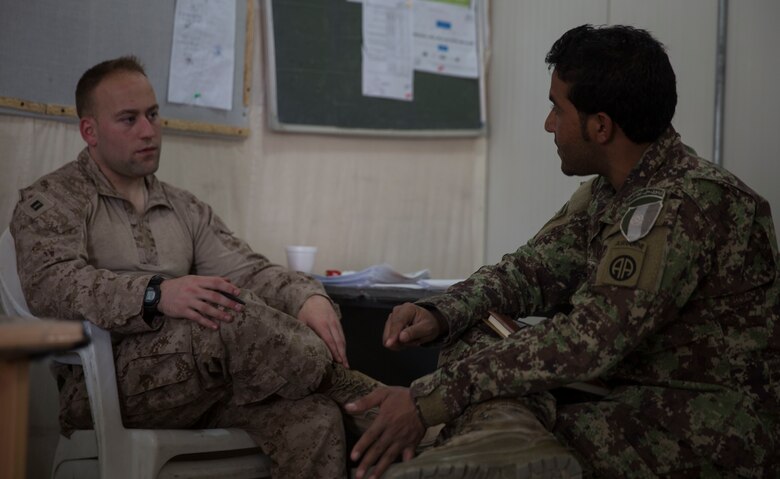 A U.S. Marine advisor with Task Force Southwest sits down and discusses capabilities, staffing and equipment that the information operations soldiers have at the 1st Brigade, near New Garm Ser, Afghanistan, Sept. 27, 2017. The advisor talked about the most efficient ways to keep the public informed and ultimately gain positive public opinion. As part of the new U.S. South Asia strategy, Marines are advising down to the brigade- and kandak-levels where necessary to support Afghan National Defense and Security Force operations. (U.S. Marine Corps photo by Sgt. Justin T. Updegraff)