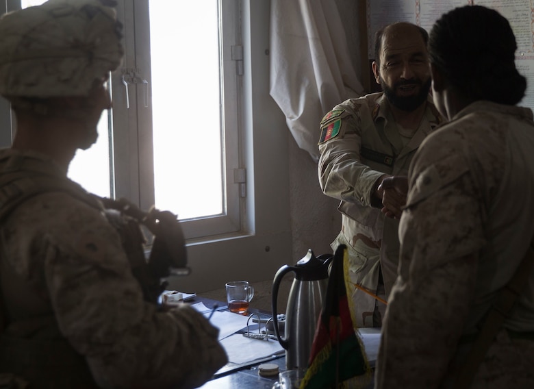 A U.S. Marine advisor with Task Force Southwest meets with the Inspector General to inquire about any known pay issues at 1st Brigade, near New Garm Ser, Afghanistan, Sept. 23, 2017. The advisor met with key leaders throughout the 1st Brigade to assist in solving any identified financial issues. As part of the new U.S. South Asia strategy, Marines are advising down to the brigade- and kandak-levels where necessary to support Afghan National Defense and Security Force operations. (U.S. Marine Corps photo by Sgt. Justin T. Updegraff)