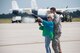 Jyl Cline, wife of Col. John Cline, deputy director of operations, Air Force Special Operations Command, prepares to hose down her husband
