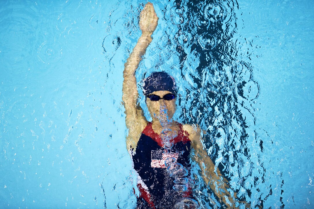 A wounded warrior does the backstroke in a pool.