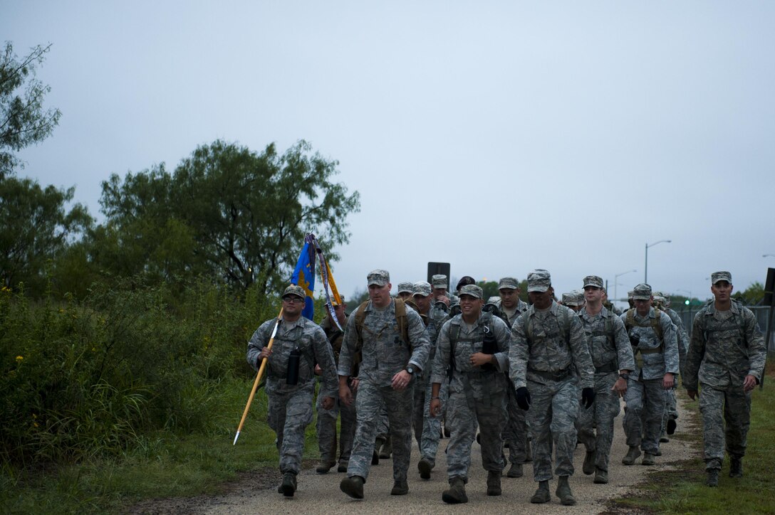Volunteers, led by U.S. Air Force Senior Master Sgt. Russell Weatherby, 17th Security Forces Squadron individual mobilization augmenter, march the perimeter road during the Jacobson ruck march on Goodfellow Air Force Base, Texas, Sept. 28, 2017. Jacobson was killed in action on Sept. 28, 2005, on patrol near the Iraqi town of Safwan. Her vehicle was hit by an improvised explosive device, killing her and U.S. Army Sgt. Steve Mornin. She was the first security forces Airman and first female Airman to die in Operation Iraqi Freedom. Weatherby led Jacobson’s fire team and was present the day it all happened. (U.S. Air Force photo by Senior Airman Scott Jackson/Released)