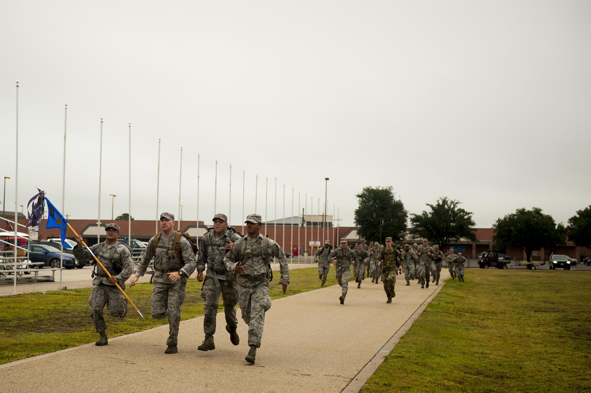 Volunteers run to the finish on the parade field during the Jacobson ruck march on Goodfellow Air Force Base, Texas, Sept. 28, 2017. The volunteers came from all over base to march in honor of Airman 1st Class Elizabeth Jacobson. (U.S. Air Force photo by Senior Airman Scott Jackson/Released)