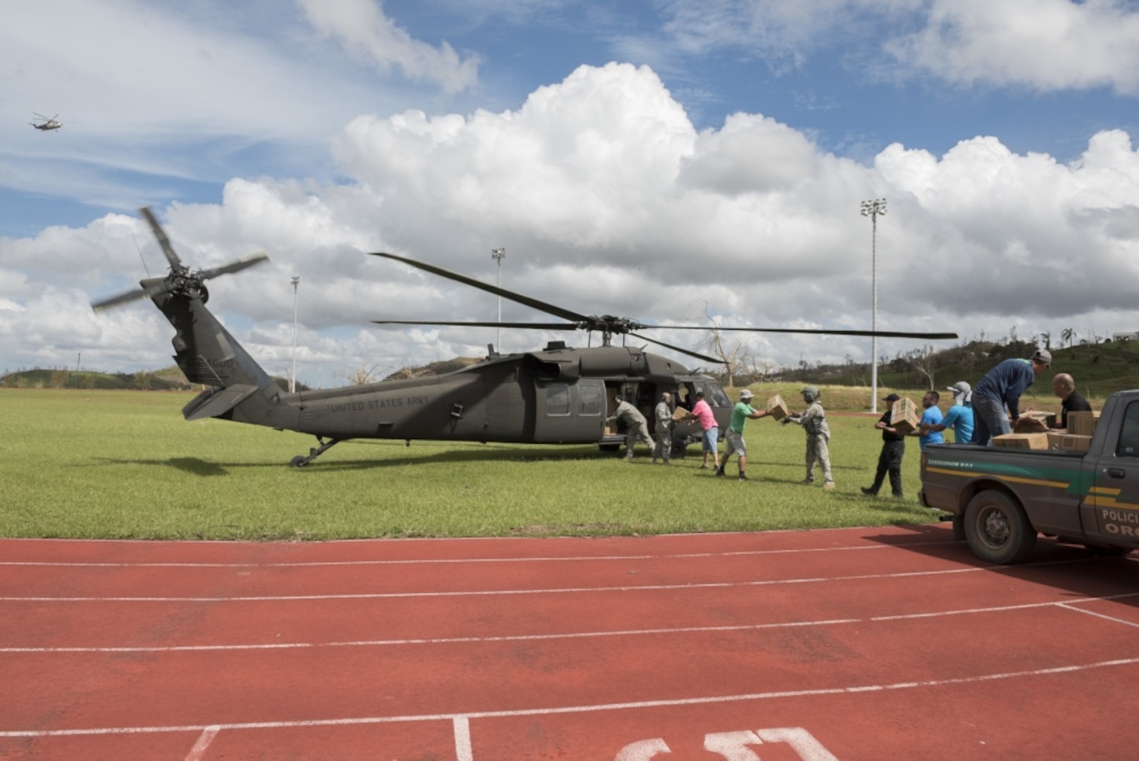 In San Juan, Puerto Rico National Guardsmen load pallets of food and water onto an UH-60 Black Hawk helicopter for distribution to Orocovis, Puerto Rico, Sept. 29, 2017. The National Guard has partnered with the Federal Emergency Management Agency and other state and federal agencies in response and relief operations for Hurricane Maria. Air National Guard photo by Air Force Staff Sgt. Michelle Y. Alvarez-Rea