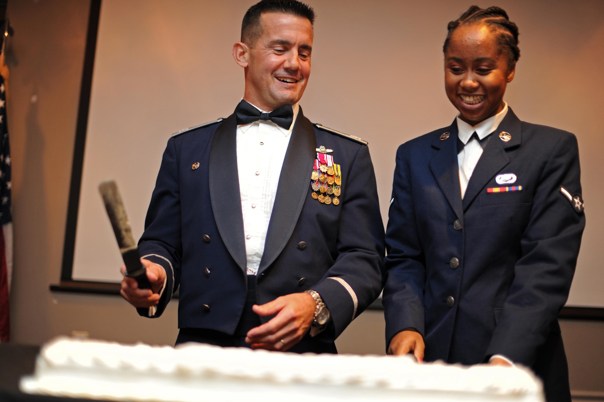 Col. Charles Velino, 47th Flying Training Wing commander and Airman Brittany Zipperian, 47th Force Support Squadron apprentice, cut the first slice of cake at the Air Force Ball at Laughlin Air Force Base, Texas, Sept. 30, 2017.  Traditionally, the oldest and youngest attendants to the ball cut the first slice of cake.