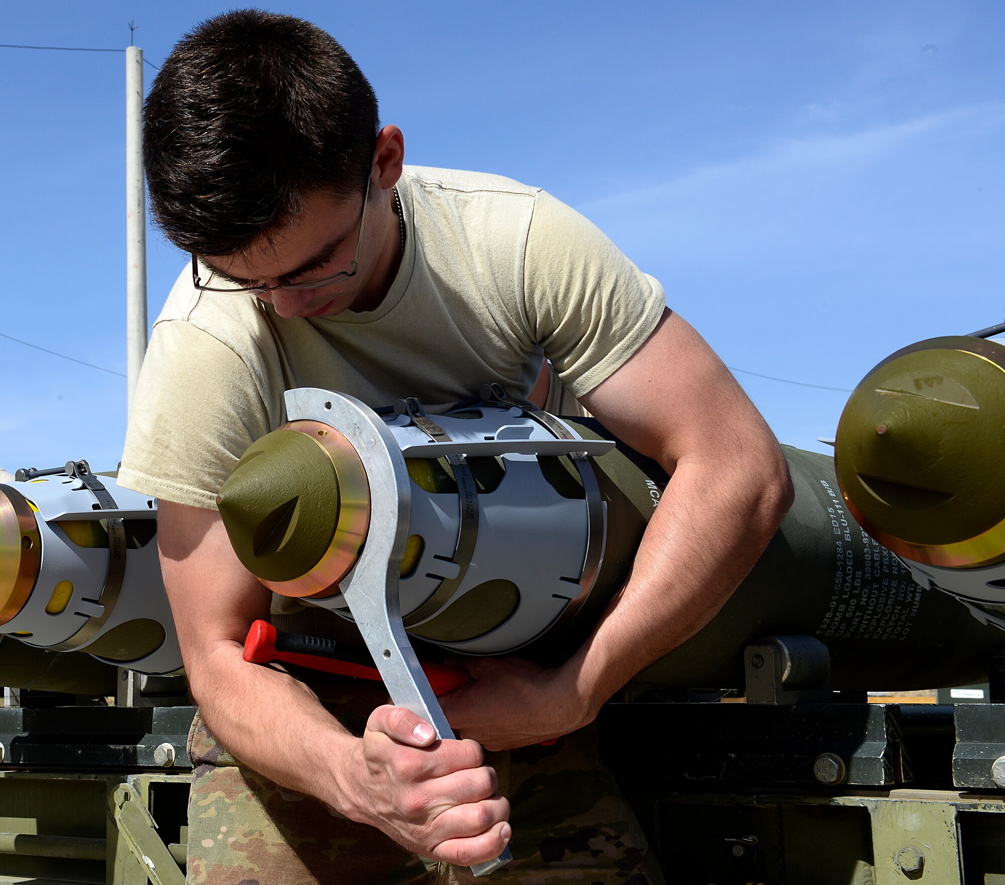 Senior Airman Ethan Dietz, 451st Expeditionary Aircraft Maintenance Squadron conventional maintenance crew member tightens a nose extender on a GBU-38 version one during a GBU-38/V1 build, March 23, 2018, at Kandahar Airfield, Afghanistan.
