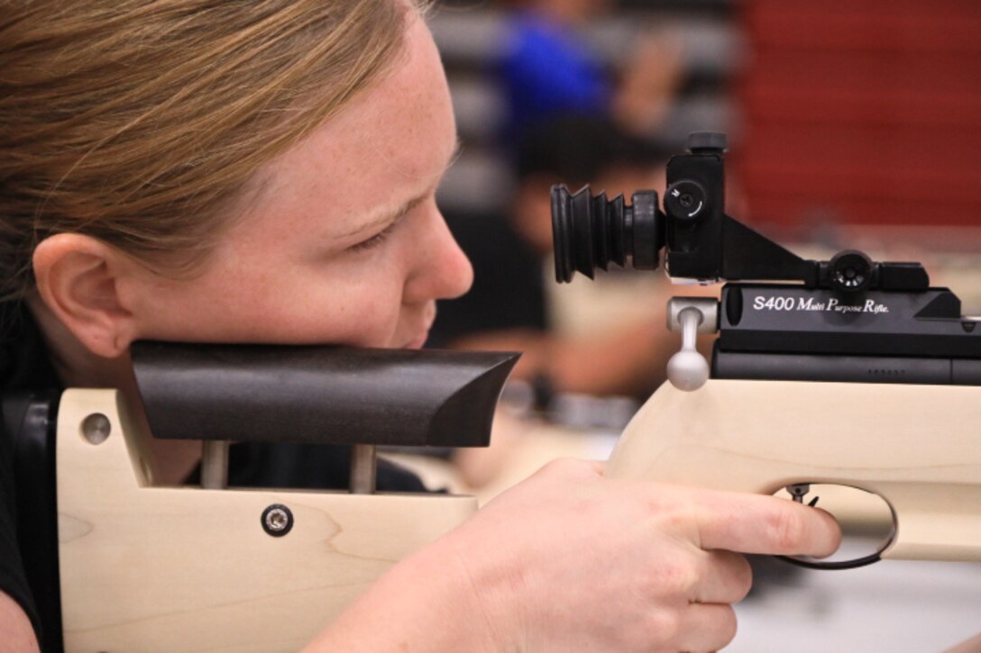 A soldier fires an air rifle.