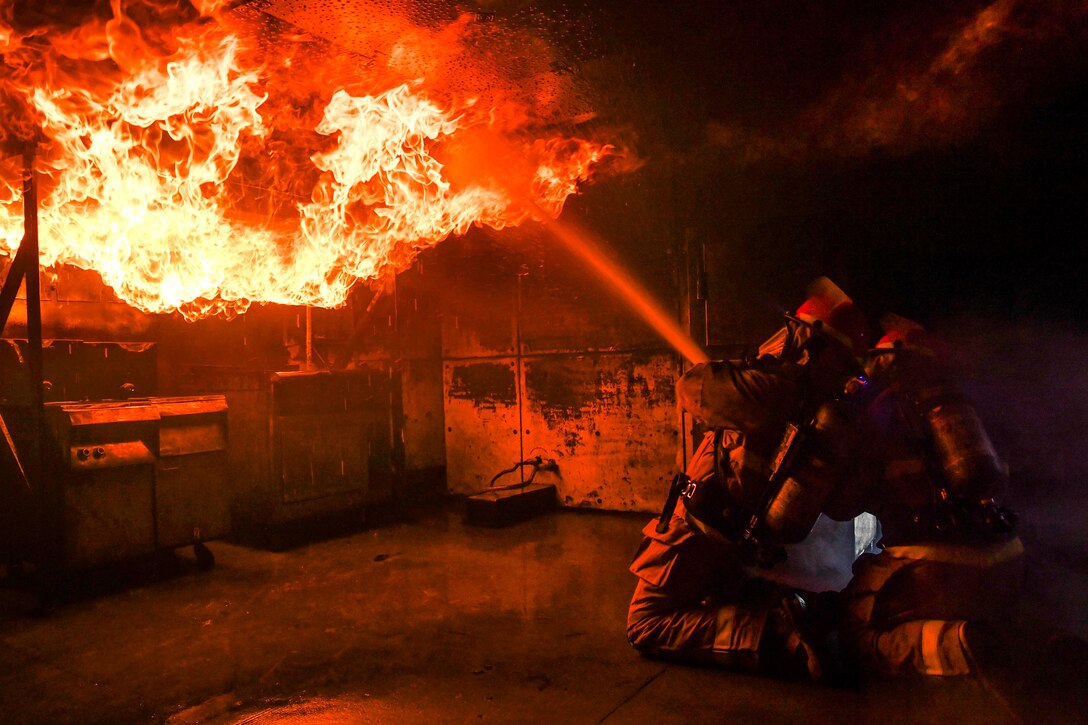 Sailors battle a training fire.
