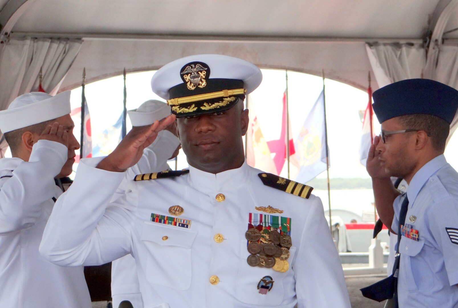 Navy Cmdr. Eric Lockett salutes