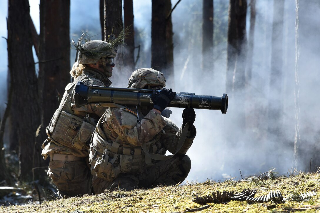 Soldiers fire an AT-4 rocket launcher.