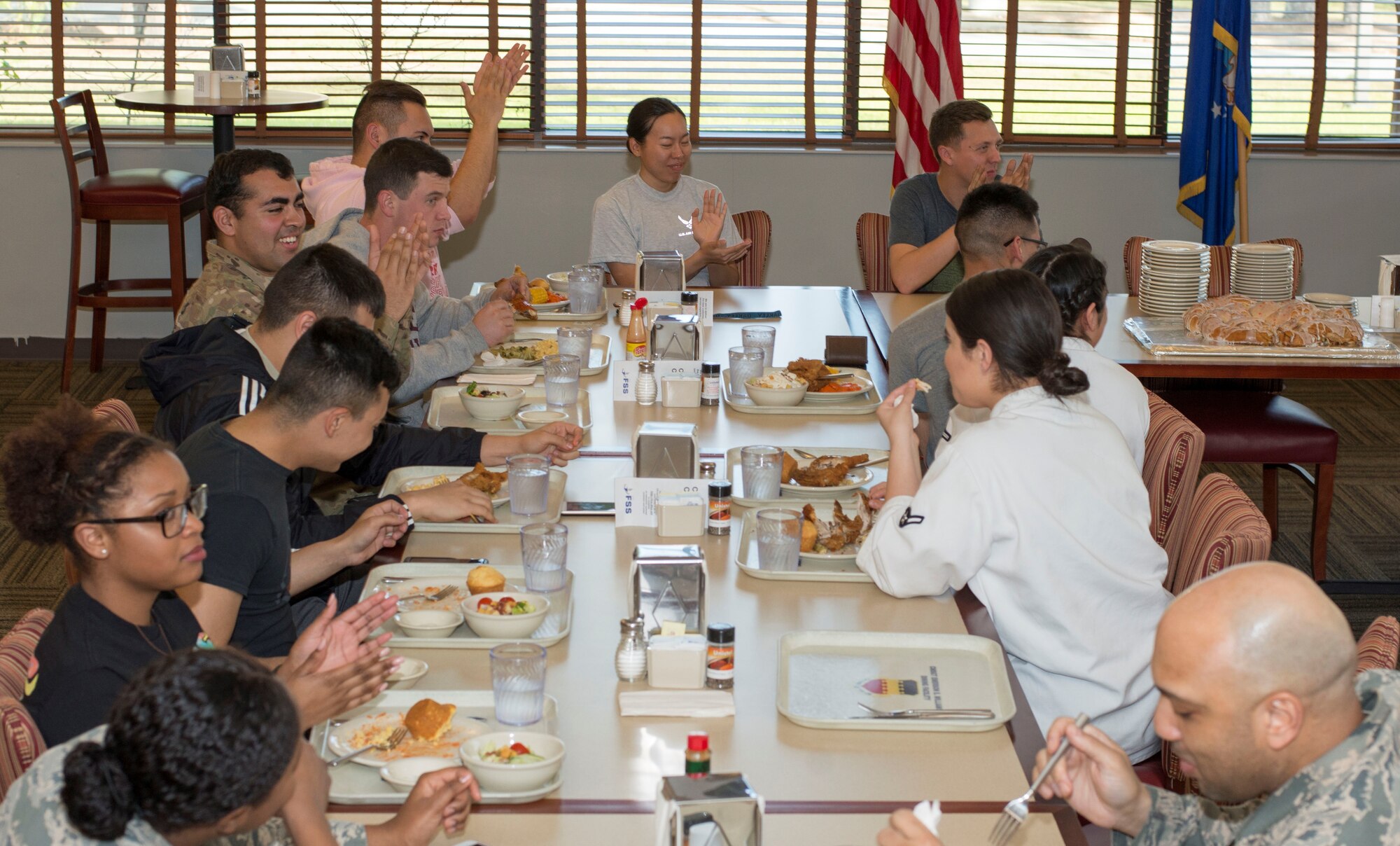 Team Shaw Airmen eat while encouraging a wingman to complete a game at the Chief Master Sgt. Emerson Williams Dining Facility at Shaw Air Force Base, S.C., March 28, 2018.