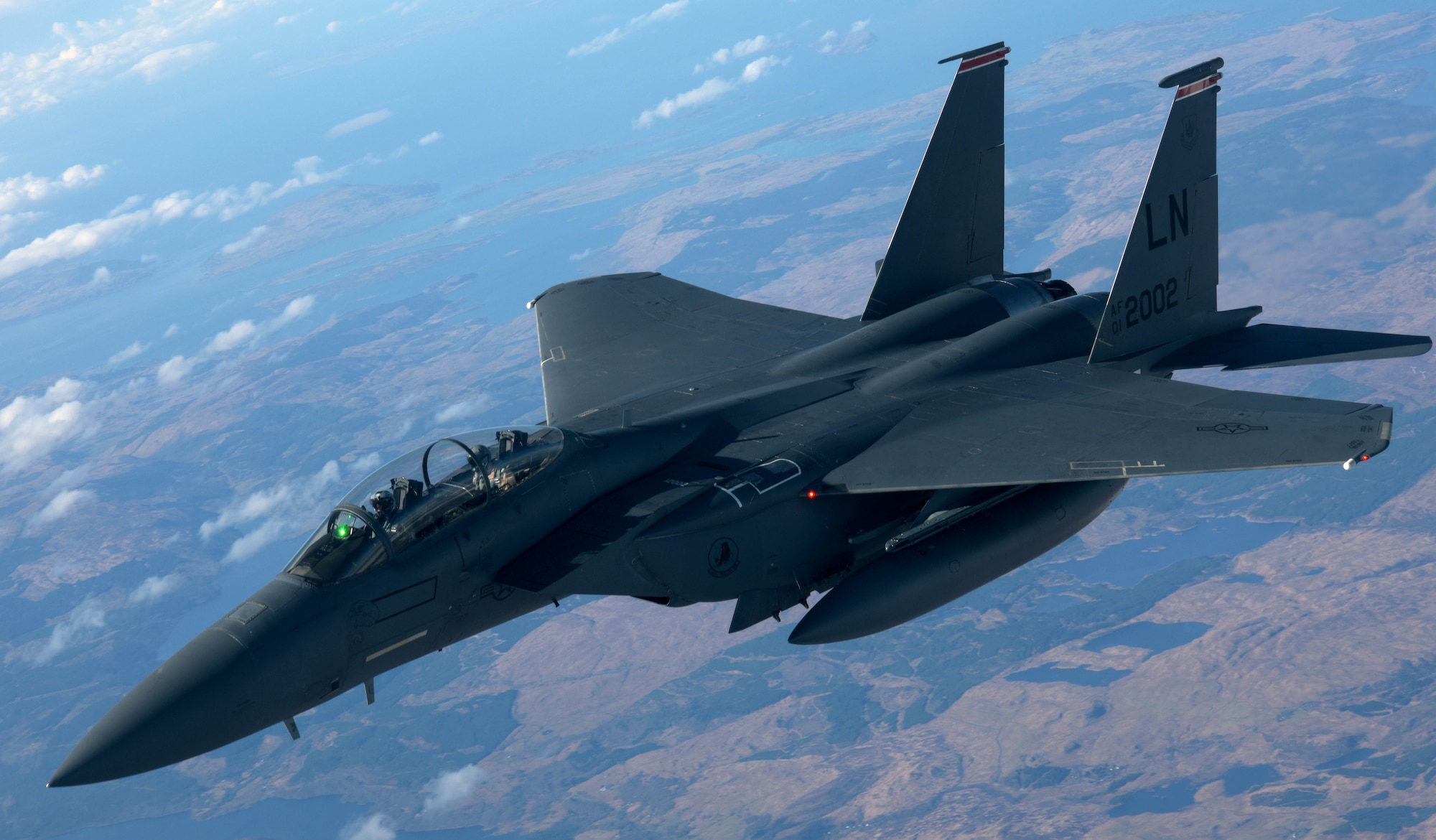 A U.S. Air Force F-15E Strike Eagle assigned to the 494th Fighter Squadron, RAF Lakenheath, flies alongside a U.S. Air Force KC-135 Stratotanker from the 100th Air Refueling Wing over Scotland, March 29, 2018. The Strike Eagle was one of eight F-15Es to receive fuel while on a training sortie. (U.S. Air Force photo by Airman 1st Class Benjamin Cooper)