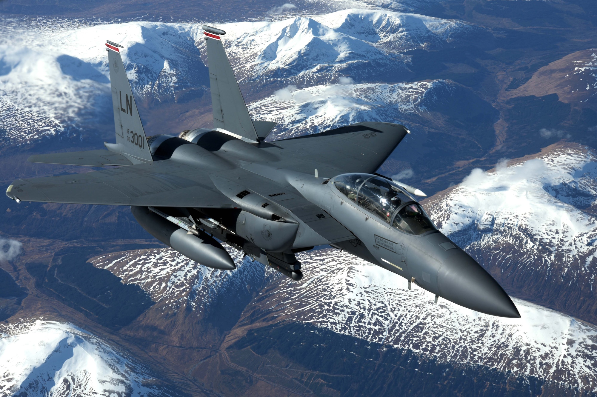 A U.S. Air Force F-15E Strike Eagle assigned to the 494th Fighter Squadron, RAF Lakenheath, flies alongside a U.S. Air Force KC-135 Stratotanker from the 100th Air Refueling Wing over Scotland, March 29, 2018. The Strike Eagle was one of eight F-15Es to receive fuel while on a training sortie. (U.S. Air Force photo by Airman 1st Class Benjamin Cooper)