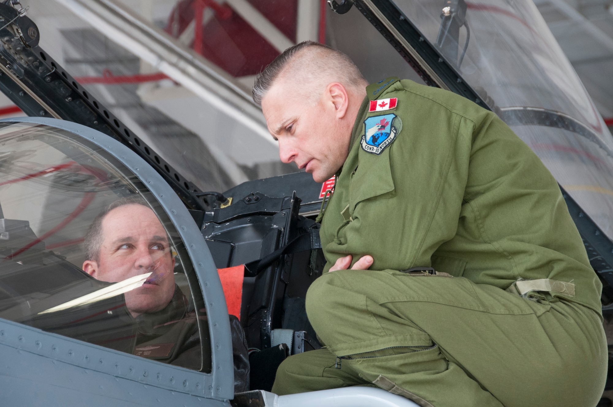 Canadian Forces Brig. Gen. Sylvain Menard, Continental US NORAD Region deputy commander, receives an orientation flight in an F-15 fighter jet and visits with air crew members during his visit to Massachusetts Air National Guard's  104th Fighter Wing at Barnes Air National Guard Base, Mar. 25, 2018. During his visit, Menard spoke to wing leadership about its homeland defense mission and its relationship with CONR to ensure continental United States aerospace control.