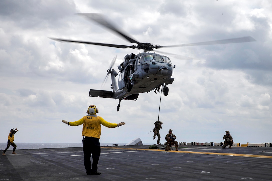 A Marine fast-ropes from an MH-60S Sea Hawk helicopter.