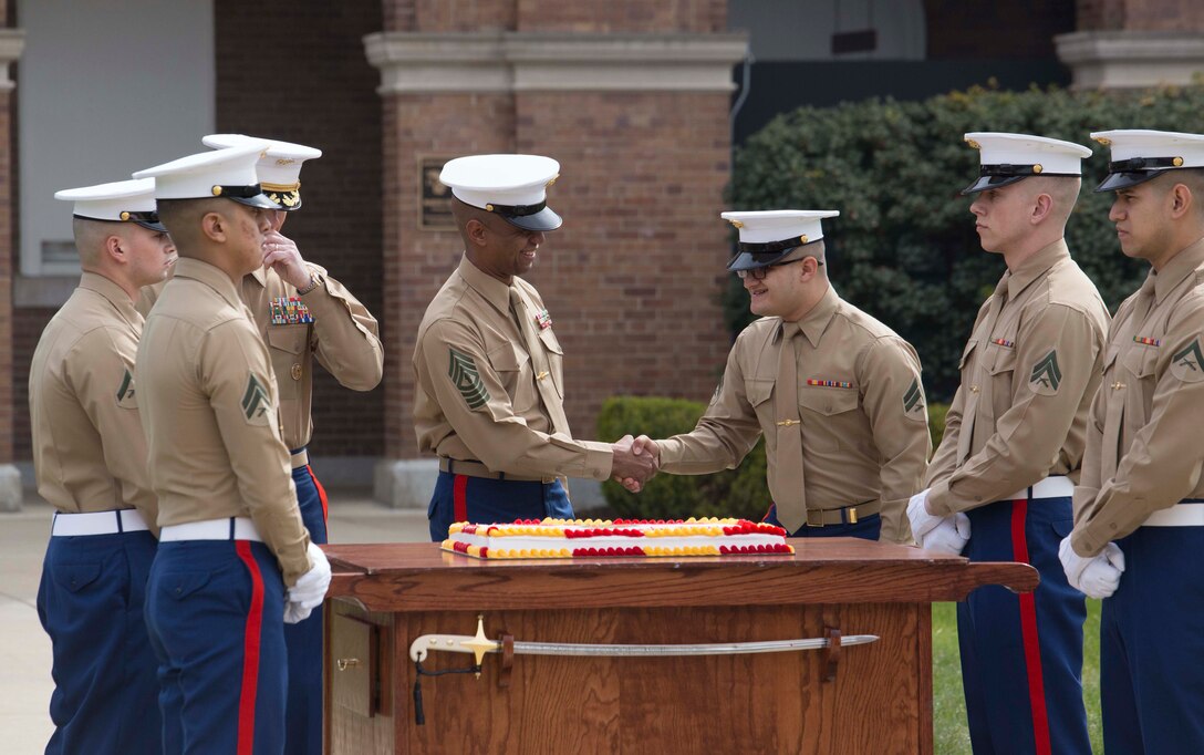 Barracks’ Marines shake hands after they share a piece of the birthday cake, at Marine Barracks Washington, Washington D.C., March 29, 2018. The Barracks hosted the celebration for its 217th Birthday at the parade deck, which included a cake cutting ceremony, and performances by the U.S. Marine Corps Color Guard and "The President's Own" U.S. Marine Corps Band. In attendance were Marine Corps veterans with the Center House Association and Marines of MBW. (U.S. Marine Corps Photo by Pfc. James Bourgeois/Released)