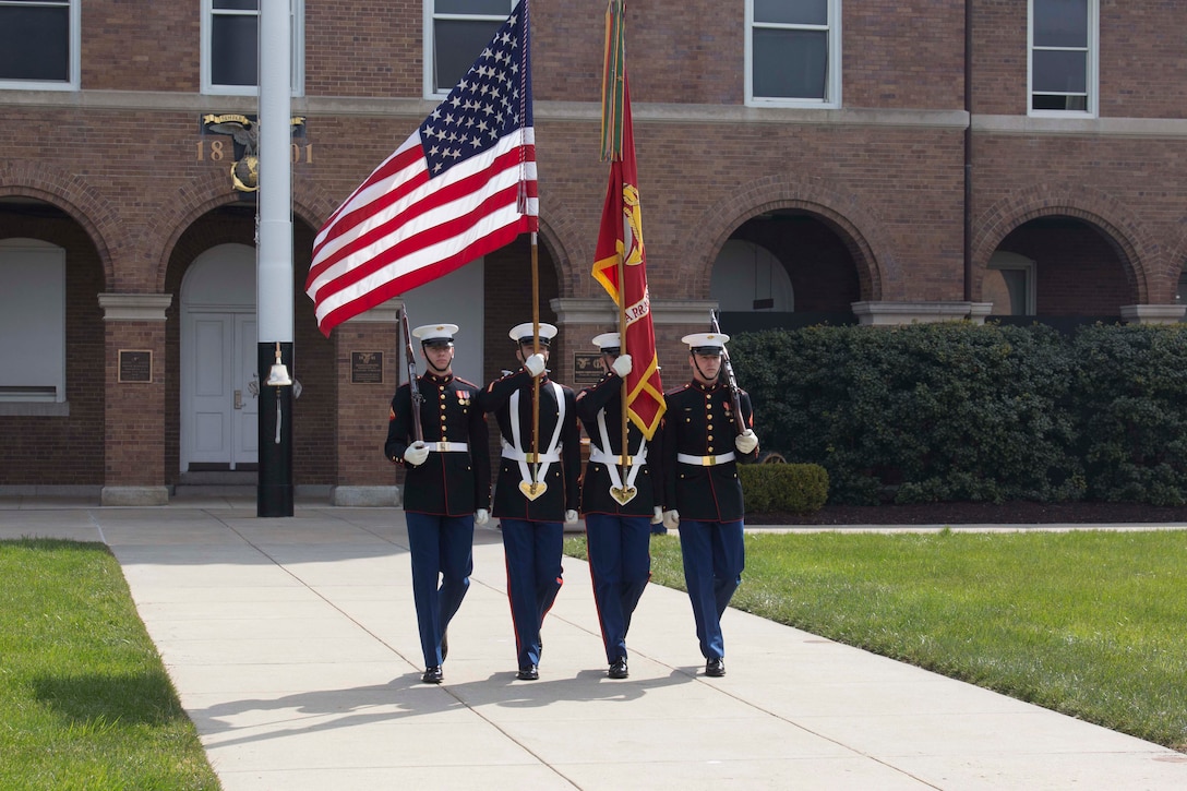 The U.S. Marine Corps Color Guard marches the National and Marine Corps Battle Colors down Center Walk during the Barracks’ 217th Birthday at Marine Barracks Washington, Washington D.C., March 29, 2018. The Barracks hosted the celebration for its 217th Birthday at the parade deck, which included a cake cutting ceremony, and performances by the U.S. Marine Corps Color Guard and “The President’s Own” U.S. Marine Band. In attendance were Marine Corps veterans with the Center House Association and Marines of MBW. (U.S. Marine Corps Photo by Pfc. James Bourgeois/Released)