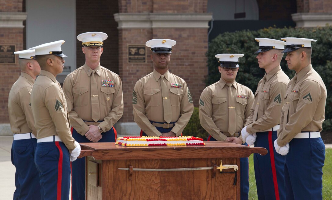 Barracks’ Marines prepare to participate in a cake cutting ceremony as a part of the Barracks’ Birthday at Marine Barracks Washington, Washington D.C., March 29, 2018. The Barracks hosted the celebration for its 217th Birthday at the parade deck, which included a cake cutting ceremony, and performances by the U.S. Marine Corps Color Guard and "The President's Own" U.S. Marine Band. In attendance were Marine Corps veterans with the Center House Association and Marines of MBW. (U.S. Marine Corps Photo by Pfc. James Bourgeois/Released)