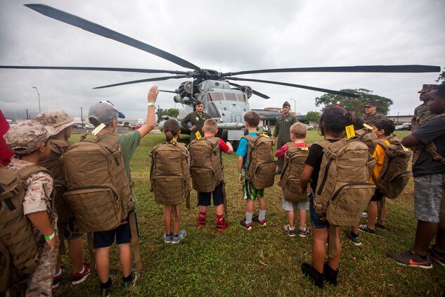 Marines with Marine Heavy Helicopter Squadron 463, Marine Aircraft Group 24, teach children about the functions of a CH-53E Super Stallion helicopter during ‘Operation Ooh-Rah Kids’, Marine Corps Base Hawaii (MCBH), March 23, 2018. MCBH Marines and Sailors volunteer each year to give the children a chance to experience what it’s like to be a Marine. (U.S. Marine Corps photo by Lance Cpl. Matthew Kirk)