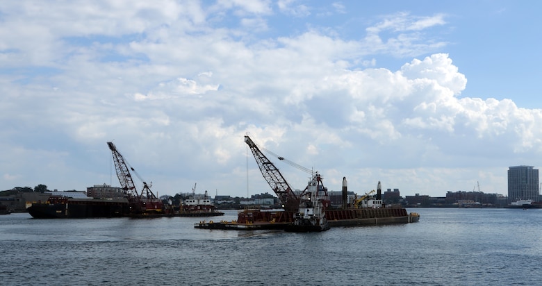 Dredges performing work in Boston Harbor.