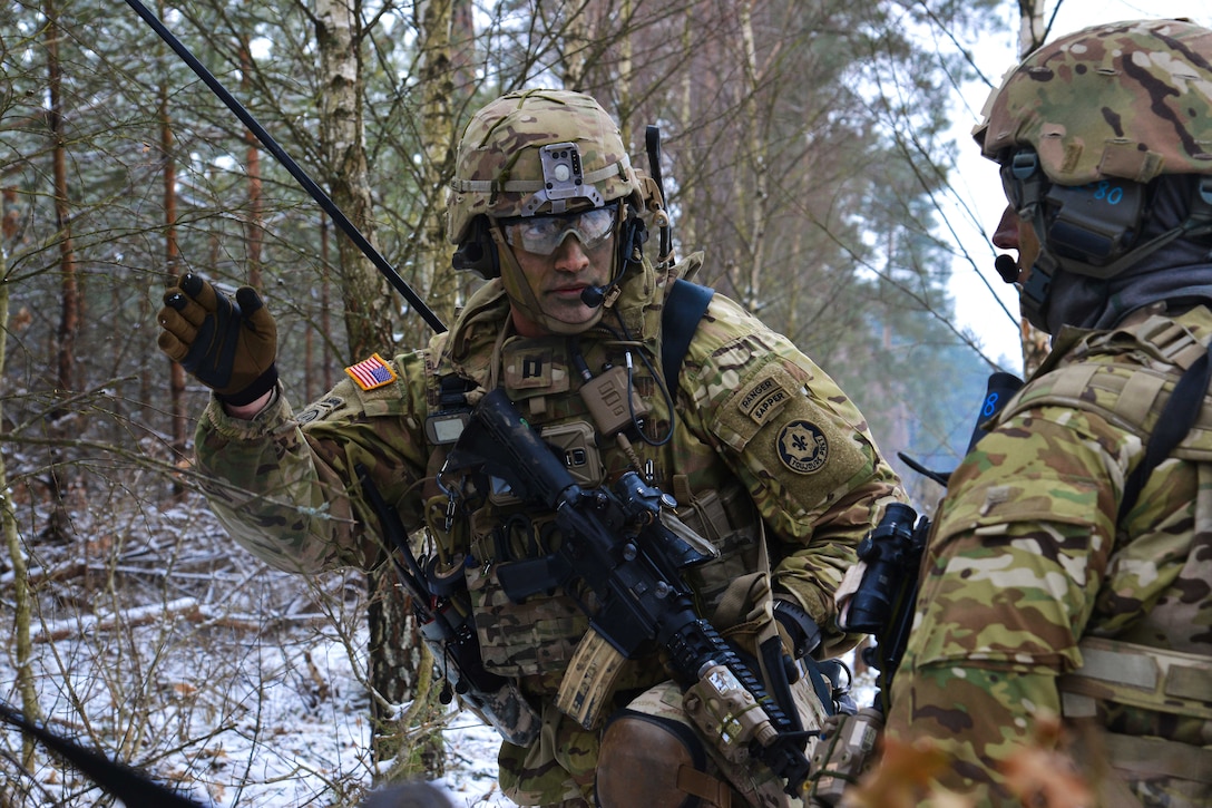 A soldier briefs a squad member.