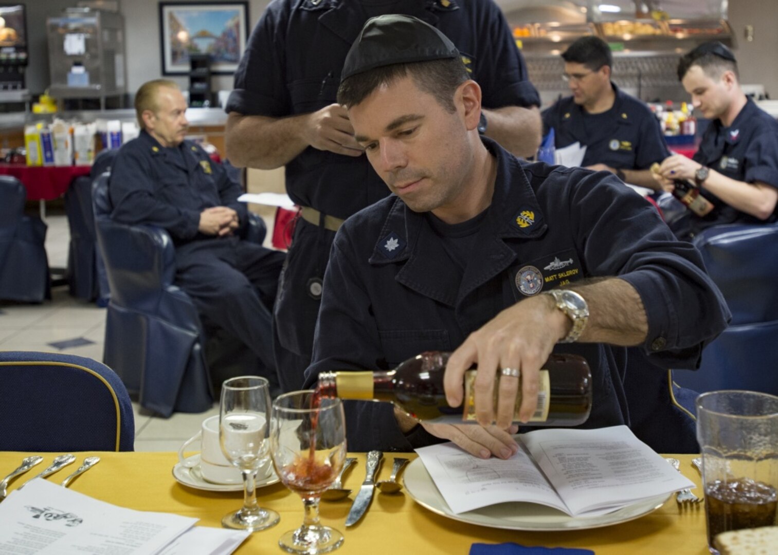 Navy Cmdr. Matt Sklerov, from New York, participates in a Passover Seder aboard the aircraft carrier USS Carl Vinson in the South China Sea, April 10, 2017. DLA Troop Support provides annual religious support to service members across the globe for the Easter and Passover holidays. This year, Troop Support provided more than 170,000 pounds of food, 11,000 Meals, Ready-to-Eat and 115 orders of palm, wine, Jewish ceremonial Seder kits and ashes.