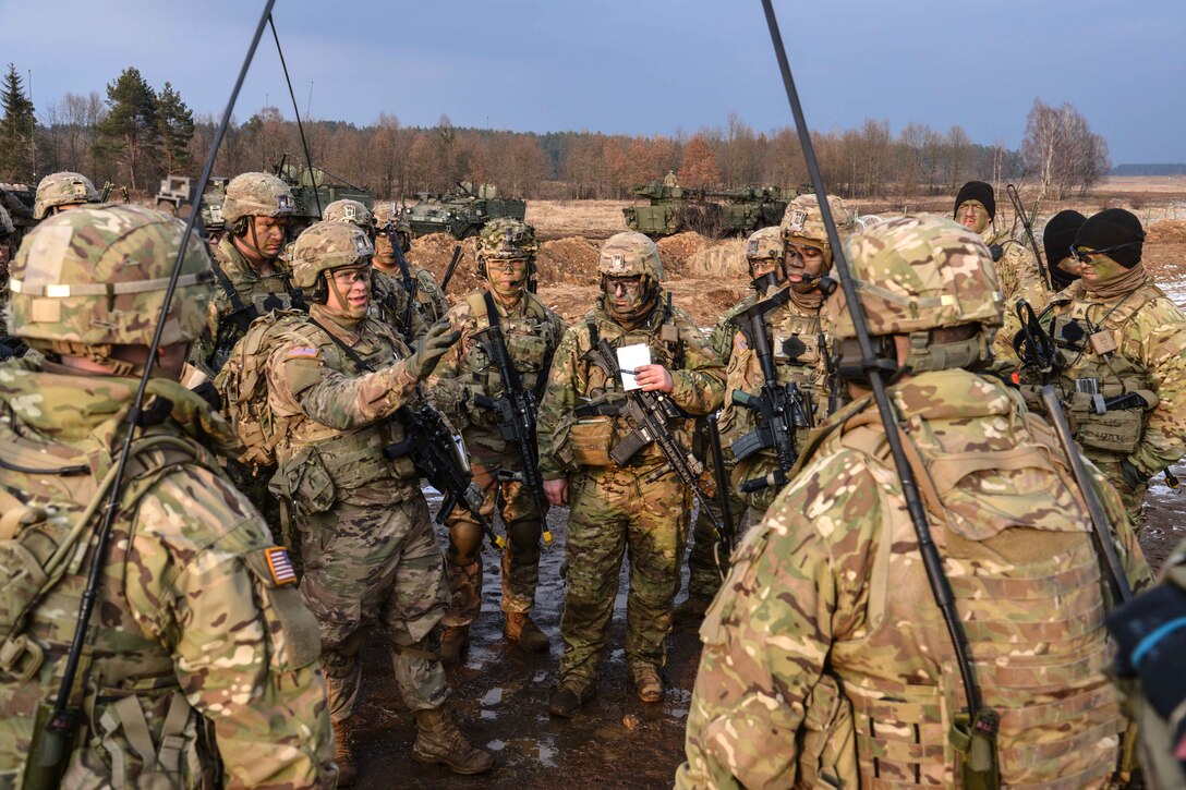 Soldiers conduct a small group after action review.