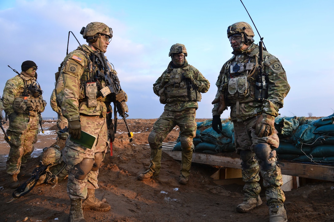 Soldiers discus the commander’s intent during an after action review.