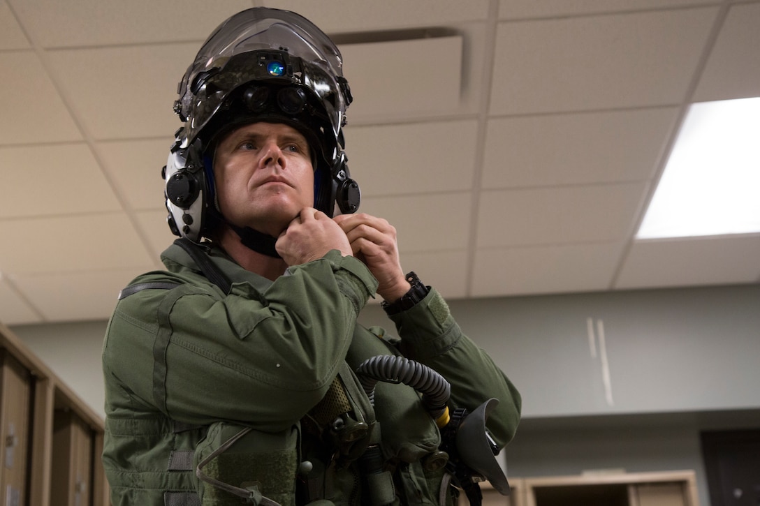 The Commanding Officer of Marine Fighter Attack Squadron 122 (VMFA-122), Lt. Col. John P. Price, straps his helmet on in preperation of VMFA-122's first flight operations in an F-35B Lightning II on Marine Corps Air Station (MCAS) Yuma, Ariz., March 29, 2018. VMFA-122 is conducting the flight operations for the first time as an F-35 squadron.